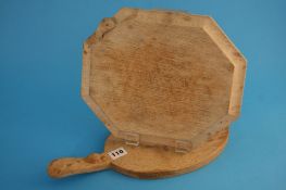 A Robert Mouseman Thompson of Kilburn oval cheeseboard and another. (2)