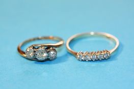 An 18ct gold and five stone diamond ring and a 9ct three stone ring. Total weight 5.4 grams