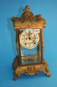 A 20th century gilt metal mantle clock by Ansonia Clock Co New York, with cream dial, glazed doors
