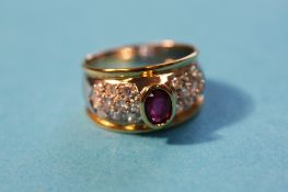 An 18ct gold ring set with a central ruby and diamond encrusted.