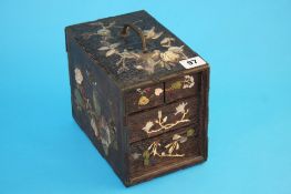 An early 20th century Shibayama lacquered travelling chest decorated with coloured ivory and