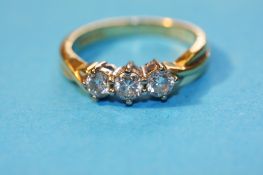 An 18ct gold three stone diamond ring.