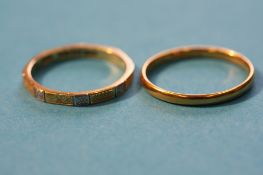 A 22ct gold wedding band, 1.8 grams and an 18ct gold ring, weight 2.3 grams.