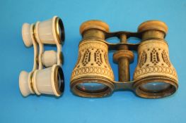 A pair of ivory clad opera glasses with pierced fretwork decoration and a small pair of opera