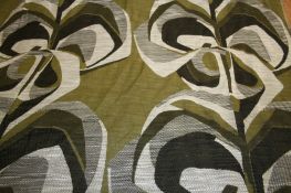 A large roll of Edinburgh Weavers `Kabandi` pattern woven fabric on an olive green ground with white