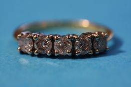 An 18ct gold diamond ring set with five diamonds.
