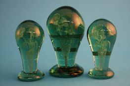 A Victorian green glass dump with central bouquet of flowers and two matching small dumps. (3) 14 cm