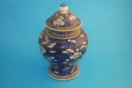 A Chinese blue and white porcelain baluster shape vase and cover, decorated with prunus, marks to