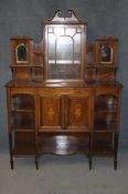 An Edwardian mahogany and inlaid side cabinet, the raised back with central glazed door flanked by