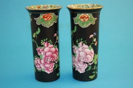 A pair of Carlton Ware "Kang Hsi" vases on a black ground and decorated with flowers, blue printed