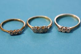 Three various 18ct gold diamond three stone rings.