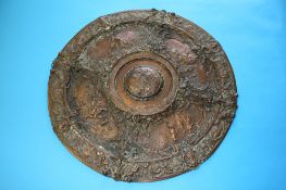 A Victorian copper circular plaque in relief, decorated with Classical scene. 48 cm diameter