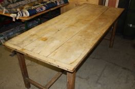 An antique pine farmhouse kitchen table with bleached 3 plank top, supported on square legs and