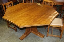 A Robert "Mouseman" Thompson of Kilburn octagonal dining table with carved mouse, supported on