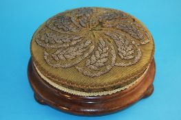 A pair of Victorian circular footstools with upholstered and beadwork decoration to the tops,