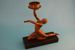 An Art Deco spelter figural table lamp, the nude female figure holding her arms aloft, supported