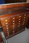A 1930`s oak tambour fronted cabinet with 32 drawers, supported on a plinth base. 111 cm wide