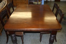 A late 19th century mahogany extending dining table with canted corners supported on fluted legs