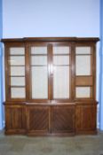 A Victorian oak breakfront bookcase with moulded cornice, below 4 panelled doors, supported on a