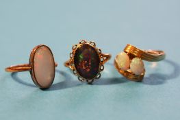 A 14ct gold opal ring and two 9ct gold opal rings. (3)