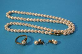 A string of pearls with a gold clasp, a 9ct gold pearl and diamond ring and a pair of earrings.