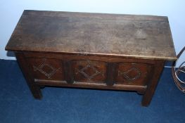 A small oak coffer with 3 carved panels to the front. 95 cm