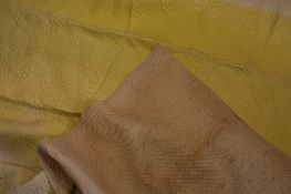 A beige and pale yellow Durham quilt.