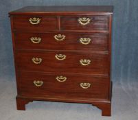 A Georgian mahogany straight front chest of drawers with 2 short and 3 long graduated drawers,