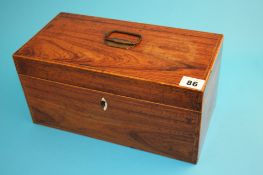 A 19th century mahogany rectangular tea caddy with fruitwood stringing opening to reveal a central