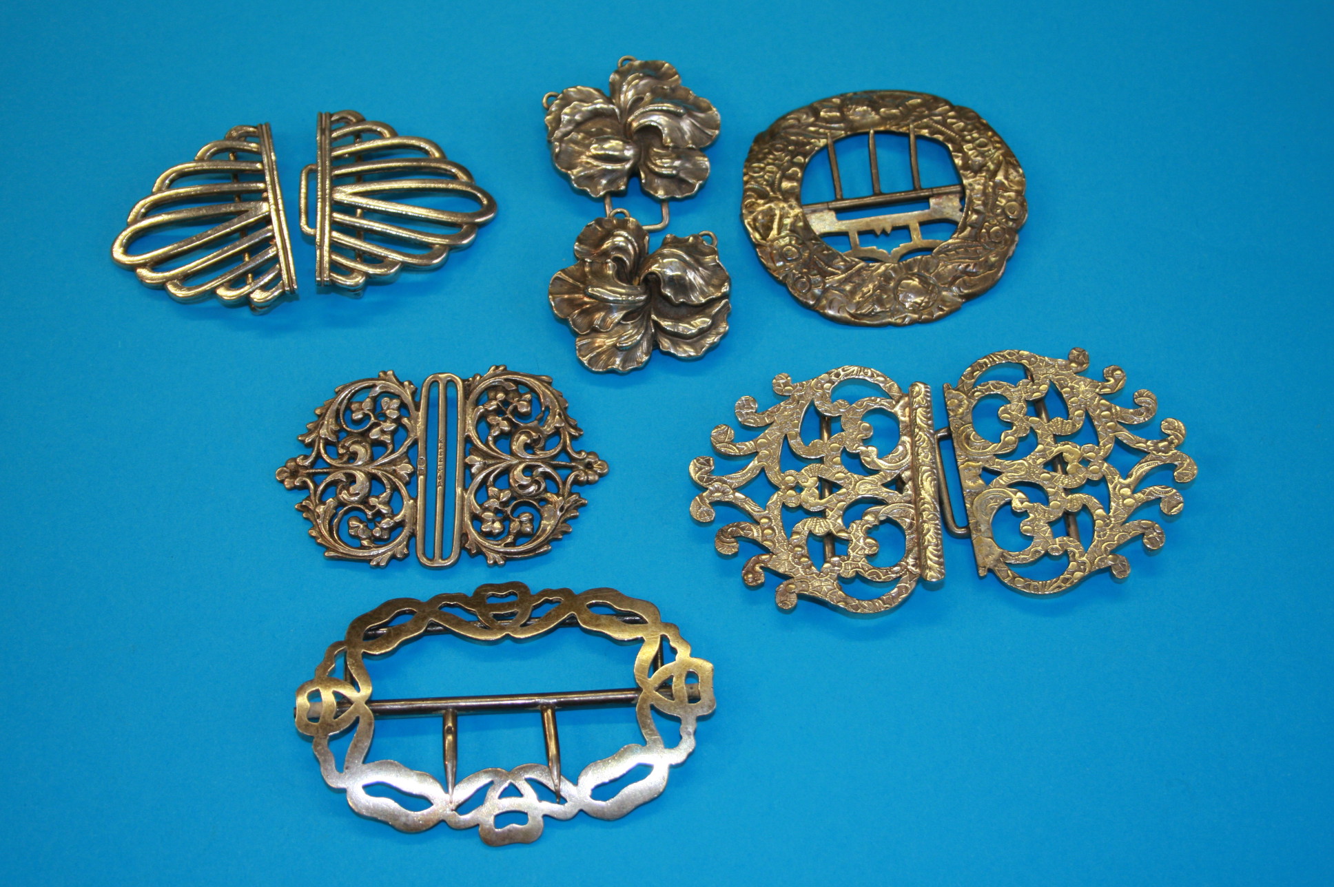 Two silver buckles and an Art Nouveau style sterling silver buckle and 3 other plated buckles. (6)