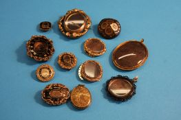 Twelve various Victorian brooches, mourning jewellery locket and pendants.