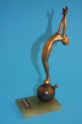 A 1930`s Art Deco spelter table lighter of a nude female with arched back and arms aloft, standing