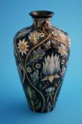 A modern Moorcroft vase of waisted form on a dark  blue ground decorated with stylised flowers,