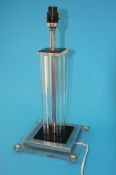 A 1960`s clear perspex and chrome table lamp supported on a stepped base. 45 cm high