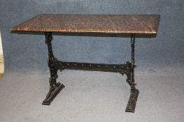 A veined marble top pub table with cast iron base. 124 cm long