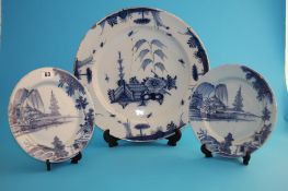 A large 18th century Delft blue and white tinglazed wall plate; and a smaller pair of blue and