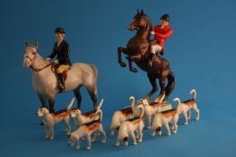 A Beswick hunting group comprising Huntsman on rearing horse, model number 868, Huntswoman, model