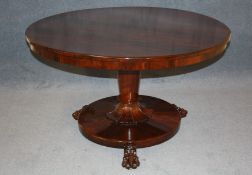 A William IV rosewood circular tilt top breakfast table, supported on a tapering central turned