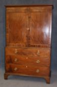 A Georgian mahogany linen press with moulded cornice below 2 panelled doors, opening to reveal pull