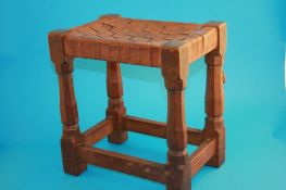 A 1930`s Robert "Mouseman" Thompson of Kilburn oak stool, lattice leather seat, octagonal legs