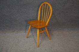 A set of six Ercol spindle back dining chairs.