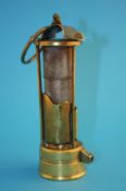 An Abbot and Co Ltd Gateshead miner`s safety lamp with hinged lid, 3 pillars with spark guard over