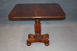 A Victorian mahogany fold over tea table with turned, fluted and reeded column, supported on a