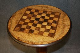 A Victorian chess top table with walnut top and mahogany central turned column supported on a