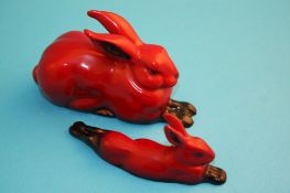 Two Royal Doulton flambe rabbits, each 10 cm long.