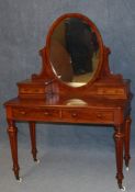 A Victorian mahogany dressing table with oval mirror flanked by two drawers, below two long drawers