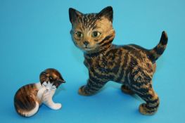 A Beswick Swiss roll cat model number 1885, 10.5 cm high; and a Royal Doulton cat HN2580, 5.5 cm