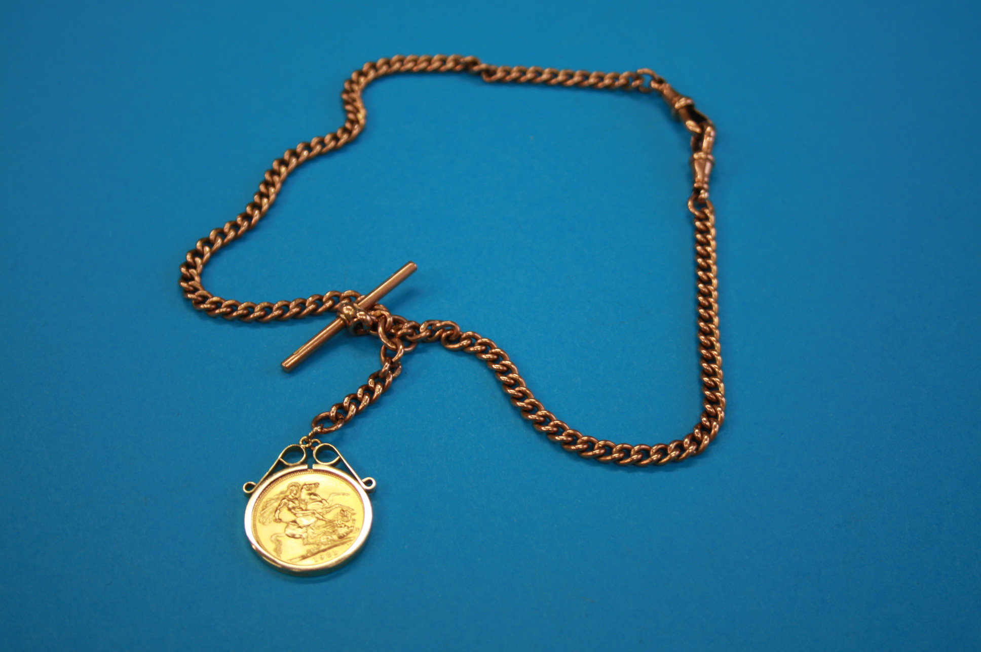 A full sovereign, 22ct gold, weight 8 grams, dated 1981; and a 9ct gold chain, 32.4 grams.