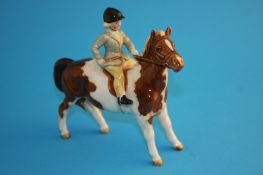 A Beswick skewbald horse with young girl (from the hunting set), model number 1499.