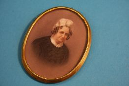 A late 19th century oval miniature of a lady mounted in a gold frame. 6.5 cm long